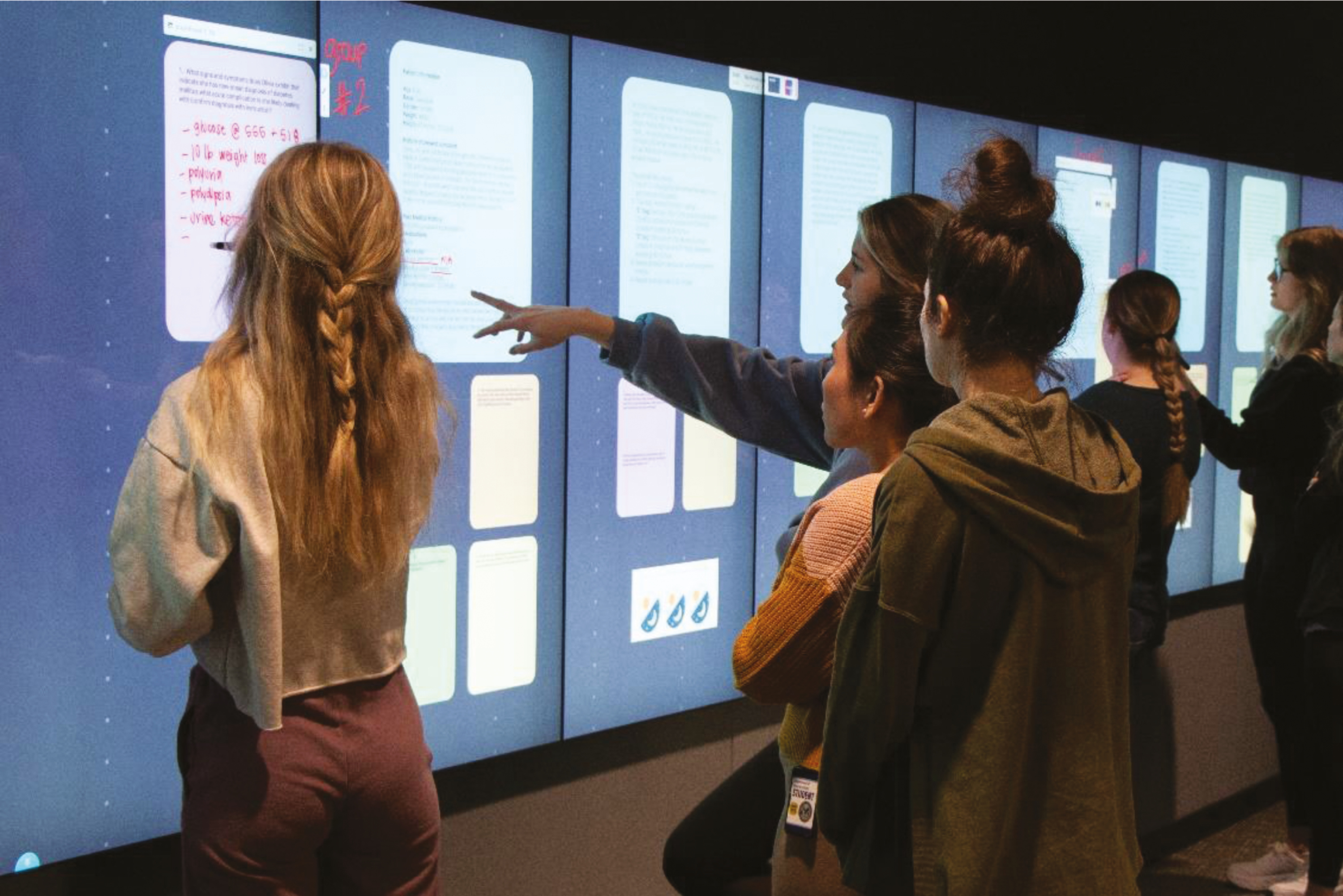 Nursing students collaborate on a case-based exercise using an interactive digital wall